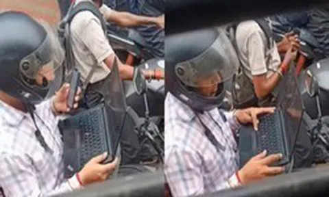 Bức ảnh gây bão mạng toàn thế giới: Mở laptop làm việc khi xe máy chờ đèn đỏ